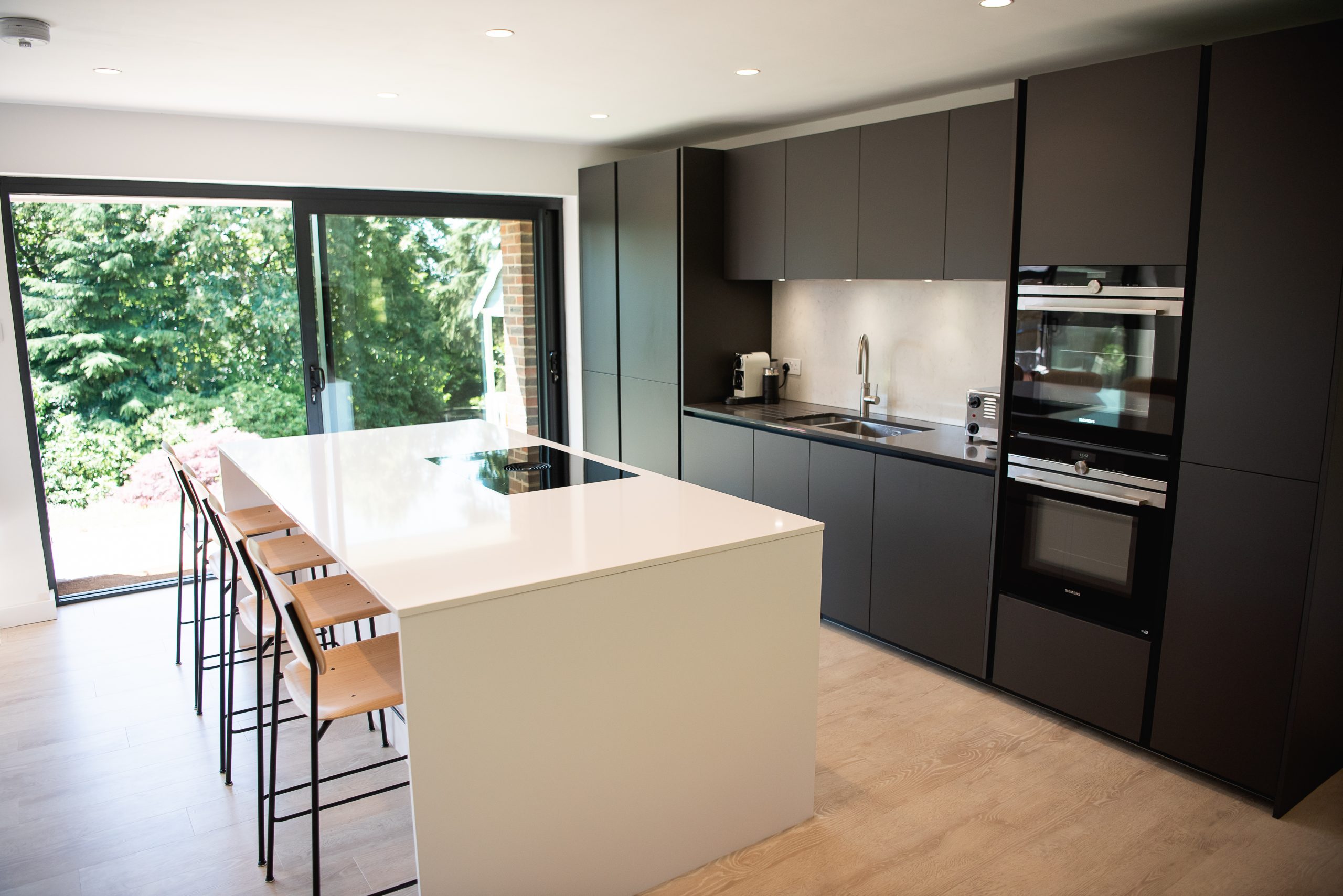 Grey and white handleless kitchen extension with island