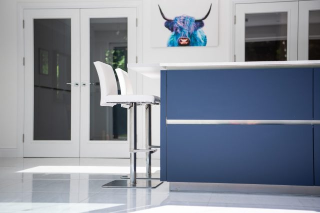 White kitchen with blue kitchen island